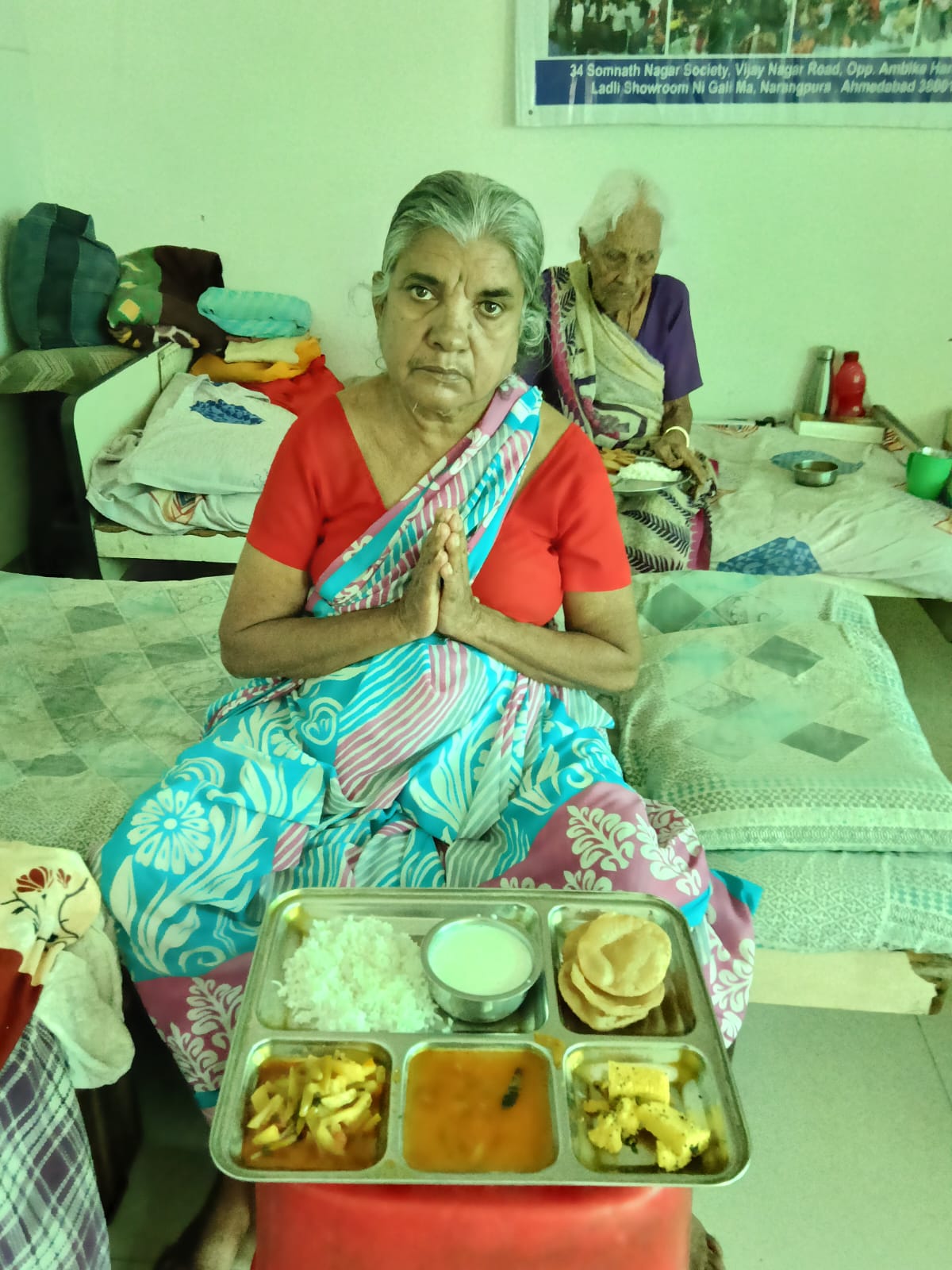 Elder resident with a complete thali meal